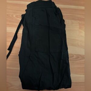 Black jogger pants cinched at the ankles